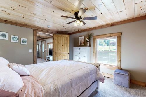 a bedroom with a bed and a ceiling fan at Morganton Escape in Morganton