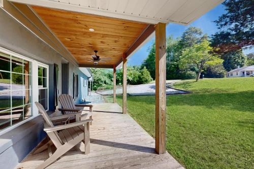 a porch of a house with two chairs on it at Morganton Escape in Morganton
