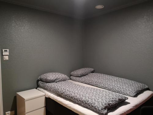 a bedroom with two pillows on top of a bed at Homestay Storesund in Storasund