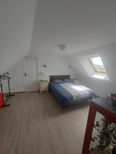 a bedroom with a bed in a room with a window at Gîte de La Garrigue in Brandonnet