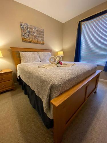 a bedroom with a bed with a hat on it at Fabulous 3 Bedroom Condo 2 miles from Disney in Orlando