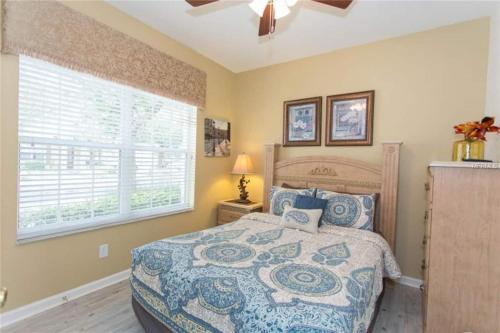 a bedroom with a large bed and a window at Windsor Hills Resort Homeprivate Pool Near Disney in Orlando