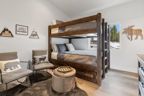 a bedroom with a bunk bed and two chairs at Quarry B10 in Whitefish