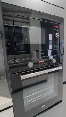 a microwave oven sitting inside of a kitchen at Adaman Villas in Meganisi