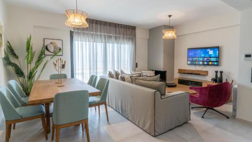 a dining room and living room with a table and chairs at Adaman Villas in Meganisi