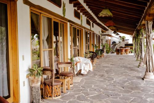 a building with chairs and tables on a sidewalk at El MURO MAJAHUA RETREAT CENTER in La Majahua