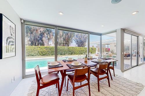 a dining room with a table and chairs and a large window at The Dunes in Bermuda Dunes