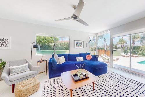 a living room with a blue couch and a chair at The Dunes in Bermuda Dunes