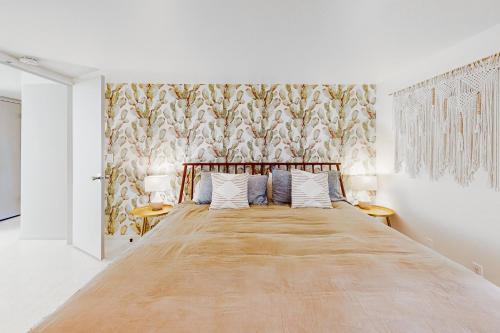 a bedroom with a large bed with a wooden headboard at The Dunes in Bermuda Dunes