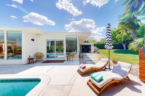 a villa with a swimming pool and a house at The Dunes in Bermuda Dunes