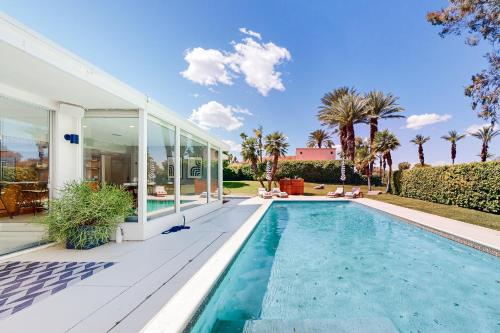 a swimming pool in front of a house at The Dunes in Bermuda Dunes