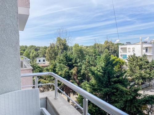 a balcony with a view of trees at LunaSol seaside Apartments in Durrës