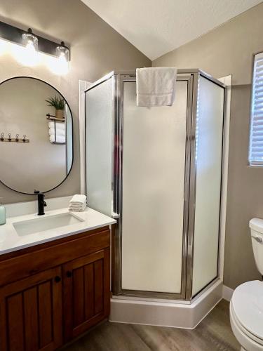 a bathroom with a shower and a sink and a mirror at Beehive Basecamp Explore Ski Play and Make Memories in Parowan
