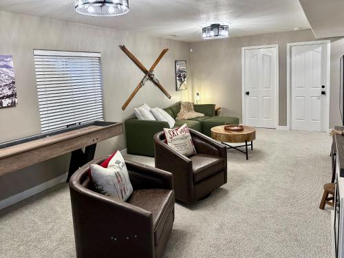 a living room with couches and chairs and a table at Beehive Basecamp Explore Ski Play and Make Memories in Parowan