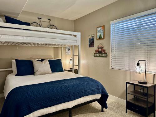 a bedroom with a bed with a blue comforter at Beehive Basecamp Explore Ski Play and Make Memories in Parowan
