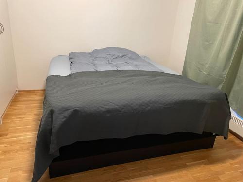 a bed with a gray blanket on top of it at Penthouse in Alta City in Alta
