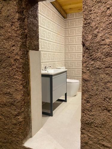a bathroom with a sink and a bath tub at Art House Kruje in Krujë