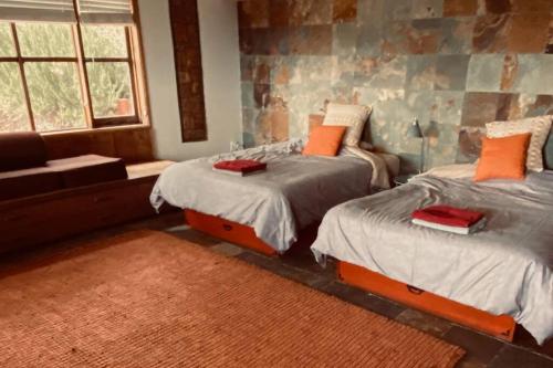 a bedroom with two twin beds and a couch at Cabin on the American Riviera in Carpinteria