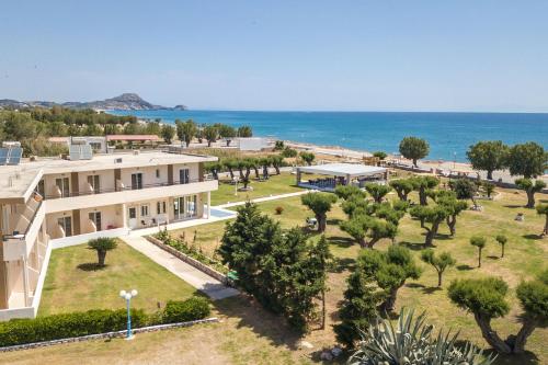 an aerial view of a building with trees and the ocean at Al Mare Apartments in Afantou