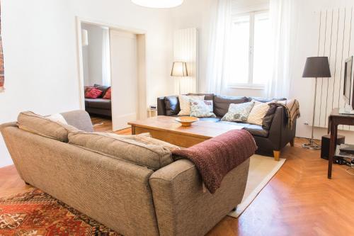 a living room with a couch and a coffee table at Tolmin Center Apartments Townhouse & Loft in Tolmin