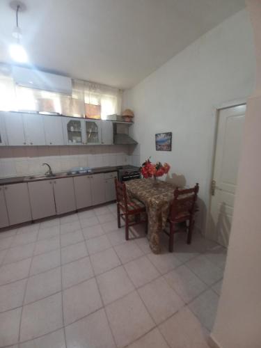 a kitchen with a table and two chairs and a table at Aleko Guest House in Gjirokastër