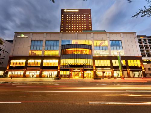 a building on a street with a tall building at Daiwa Roynet Hotel Wakayama in Wakayama