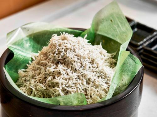 a bowl filled with rice and green leaves at Daiwa Roynet Hotel Wakayama in Wakayama
