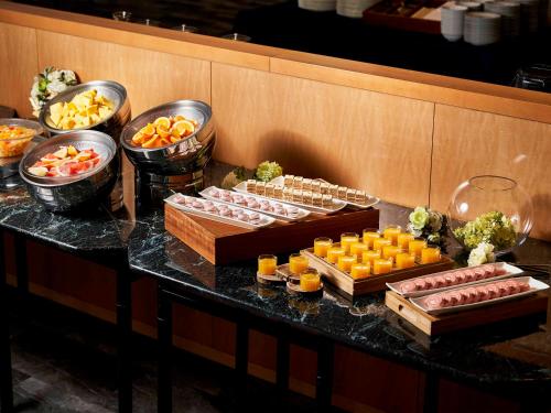 a buffet with sushi and other foods on a table at Daiwa Roynet Hotel Wakayama in Wakayama
