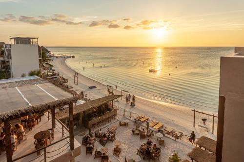 a view of the beach at sunset from a building at AWA Holbox Hotel Boutique - Beach Front in Holbox Island