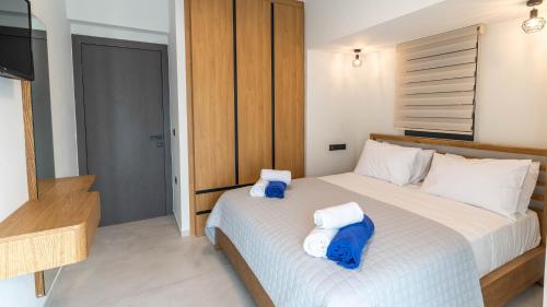 a bedroom with a bed with two towels on it at Adaman Villas in Meganisi