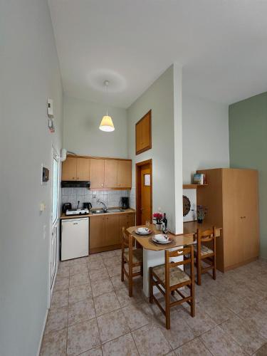 a kitchen with a table and chairs in it at My Lemnos Studios - Studio 4 in Repanídhion