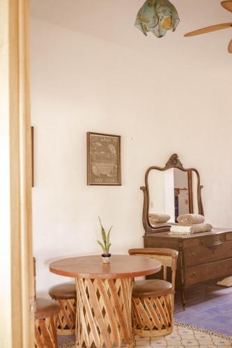 a table and chairs in a room with a mirror at El MURO MAJAHUA RETREAT CENTER in La Majahua