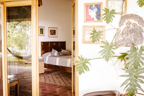 a bedroom with a bed and a mirror at El MURO MAJAHUA RETREAT CENTER in La Majahua