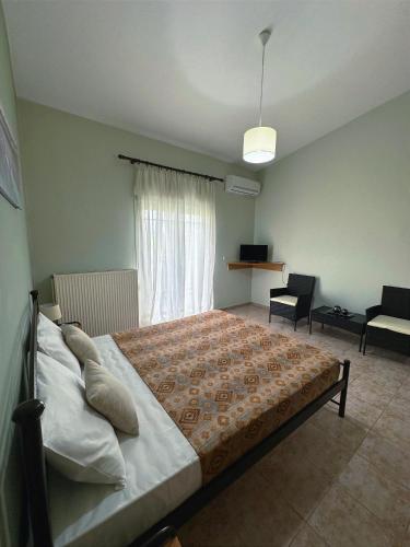 a bedroom with a large bed in a room at My Lemnos Studios - Studio 4 in Repanídhion