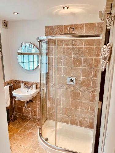 a bathroom with a shower and a sink at Inglenook of Deal in Kent