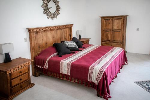 a bedroom with a large bed with pillows on it at El MURO MAJAHUA RETREAT CENTER in La Majahua