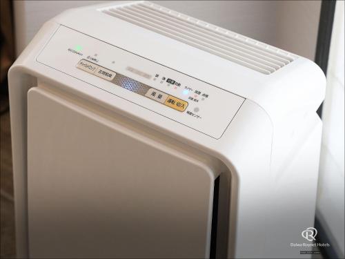 a white refrigerator with a sign on top of it at Daiwa Roynet Hotel Wakayama in Wakayama