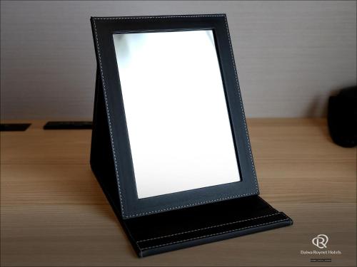 a black picture frame with a white light at Daiwa Roynet Hotel Wakayama in Wakayama