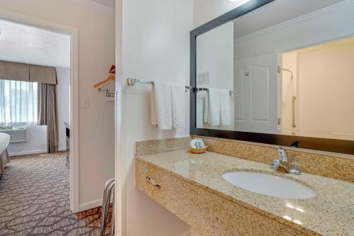 a bathroom with a sink and a large mirror at Best Western Salinas Monterey in Salinas