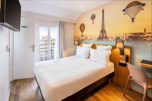 a hotel room with a bed and a mural of the eiffel tower at Hotel Apolonia Paris Mouffetard, Sure Hotel Collection by Best Western in Paris