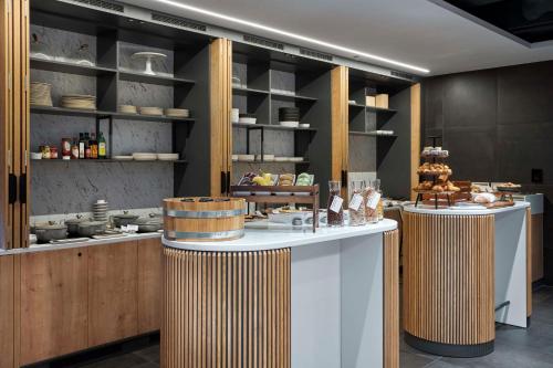 a kitchen with two counters with food on display at Radisson Hotel Budapest BudaPart in Budapest