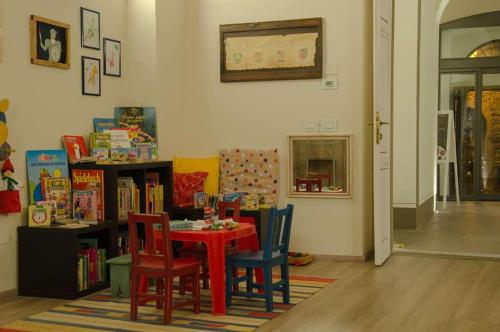 a room with a table with chairs and books at Antico Sipario Boutique Hotel, BW Signature Collection in Paciano