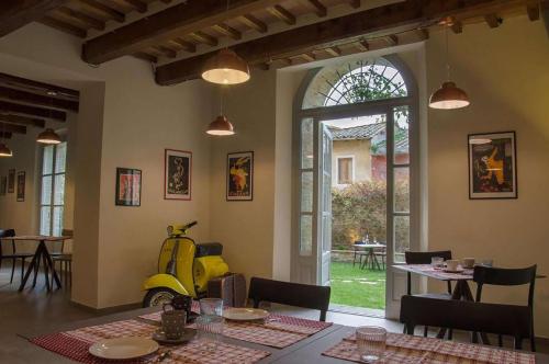 a room with a table with a yellow scooter in it at Antico Sipario Boutique Hotel, BW Signature Collection in Paciano