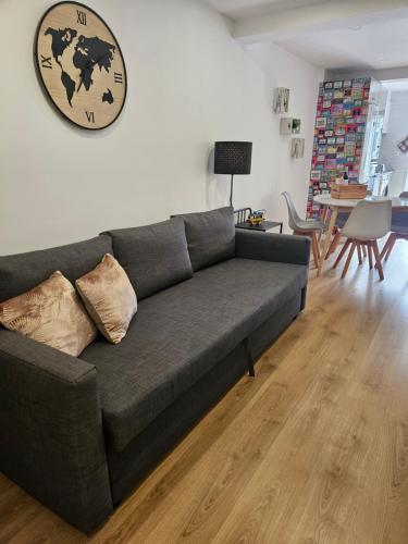 a gray couch in a living room with a table at Lisboa Bridge Spot in Lisbon