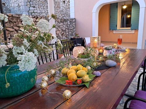 a wooden table with fruit and decorations on it at Villa Cesarica Novalja in Novalja
