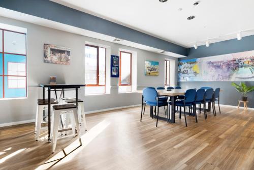 a dining room with blue chairs and a table at HI Los Angeles Santa Monica Hostel in Los Angeles