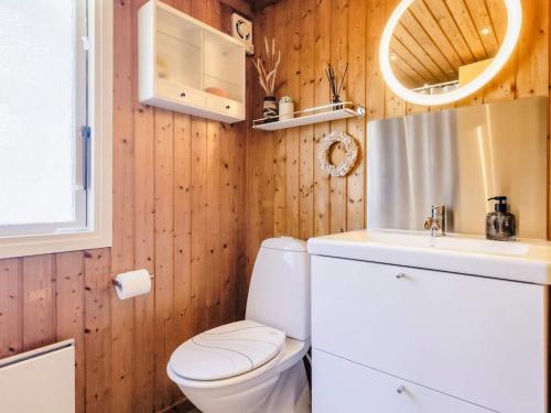 a bathroom with a toilet and a sink at Holiday home Strandby XIII in Strandby
