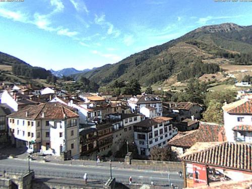 a view of a town with a road and buildings at APARTAMENTO POCO TRIGO EN POTES in Potes