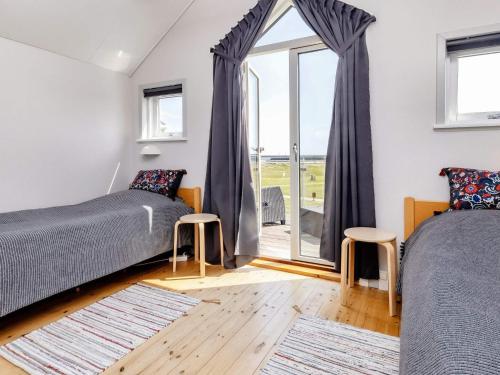 a bedroom with two beds and a window at 6 person holiday home in Hadsund-By Traum in Hadsund