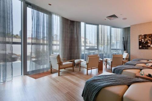 a hotel room with two beds and a balcony at Hilton- Luxury Sky Ocean Lv27 Large Apartment in Gold Coast